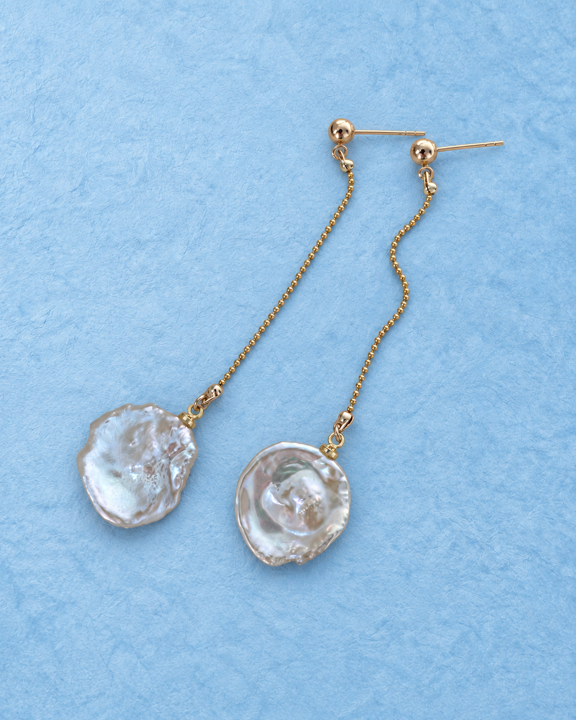 Pelara Drop Earrings on light blue background