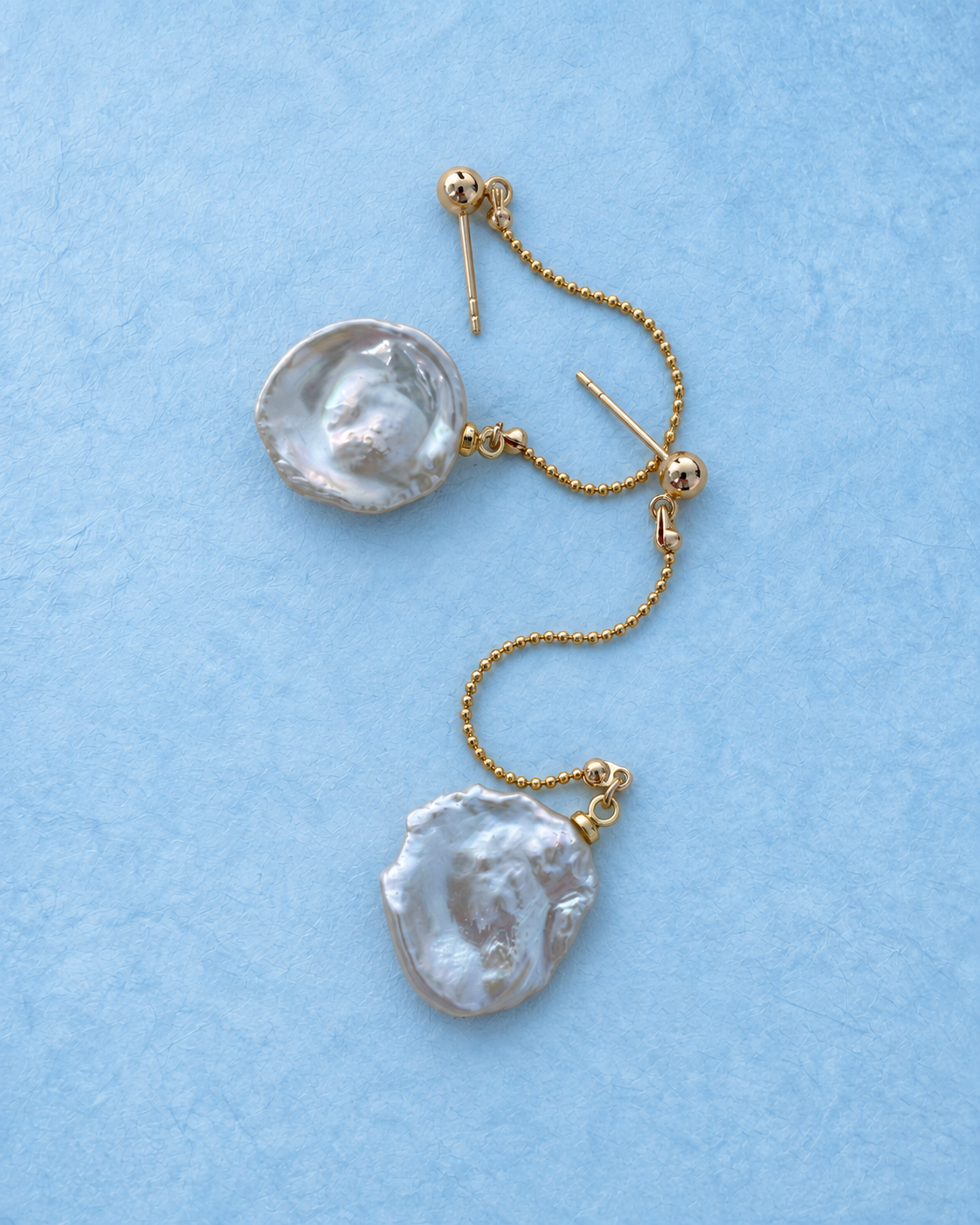 Pelara Drop Earrings on light blue background