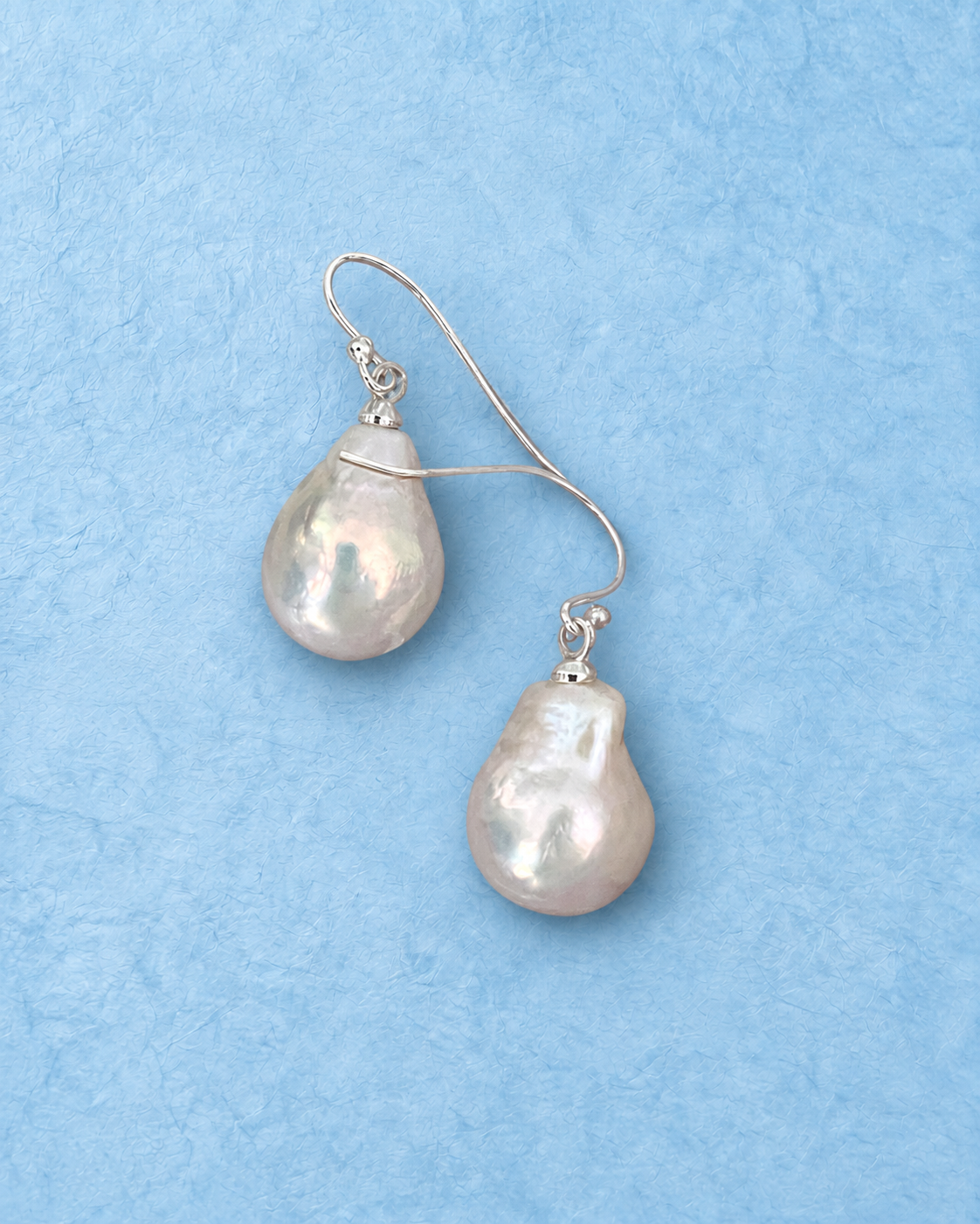 Nerelis Earrings on light blue background