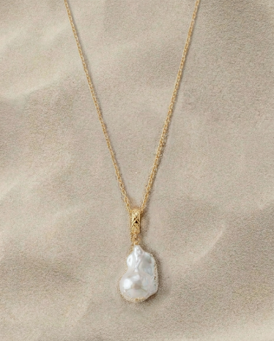 Gold clasp necklace with an irregular white pearl pendant
