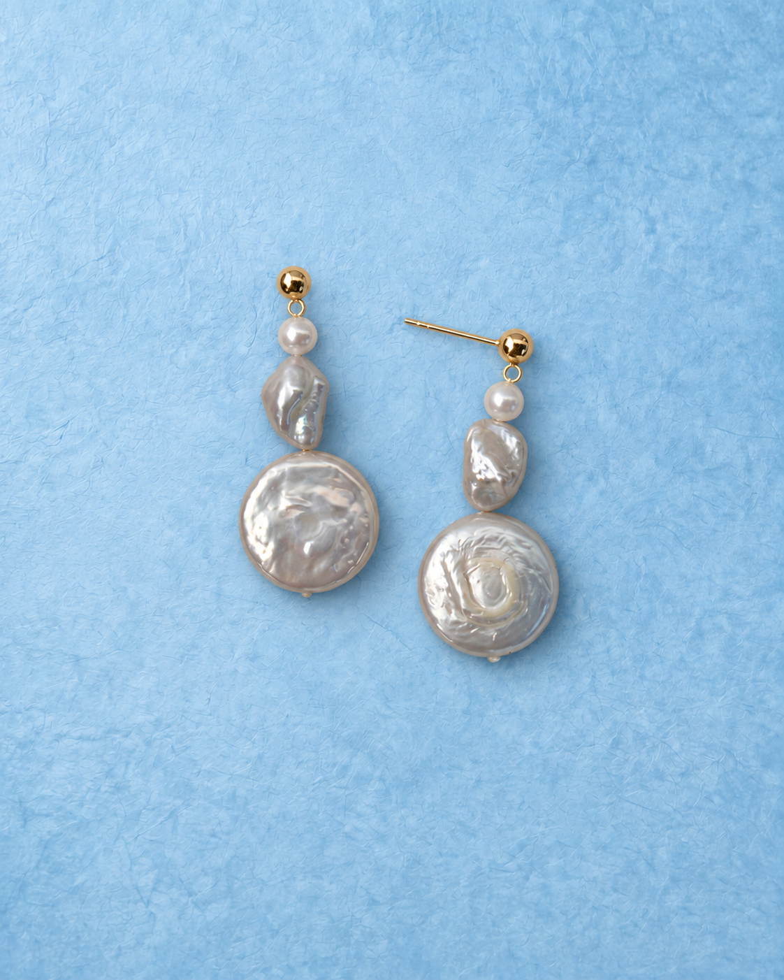 Cadelle Earrings on light blue background