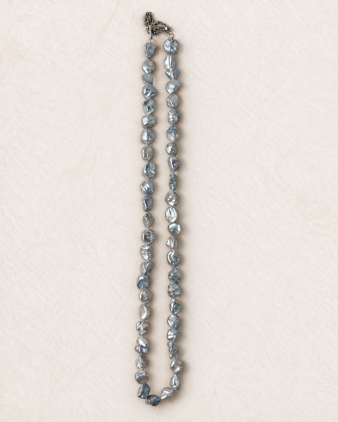 Blue Nacre Loop Necklace on ivory background, view 1