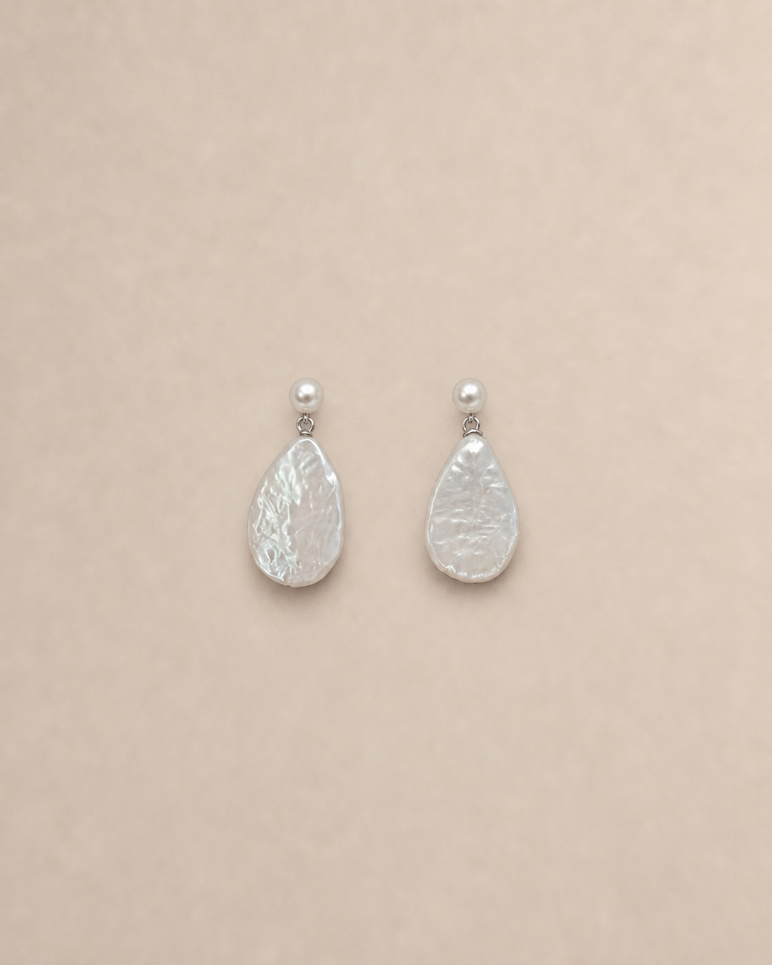 Lumen flattened baroque pearl drop earrings on warm greige