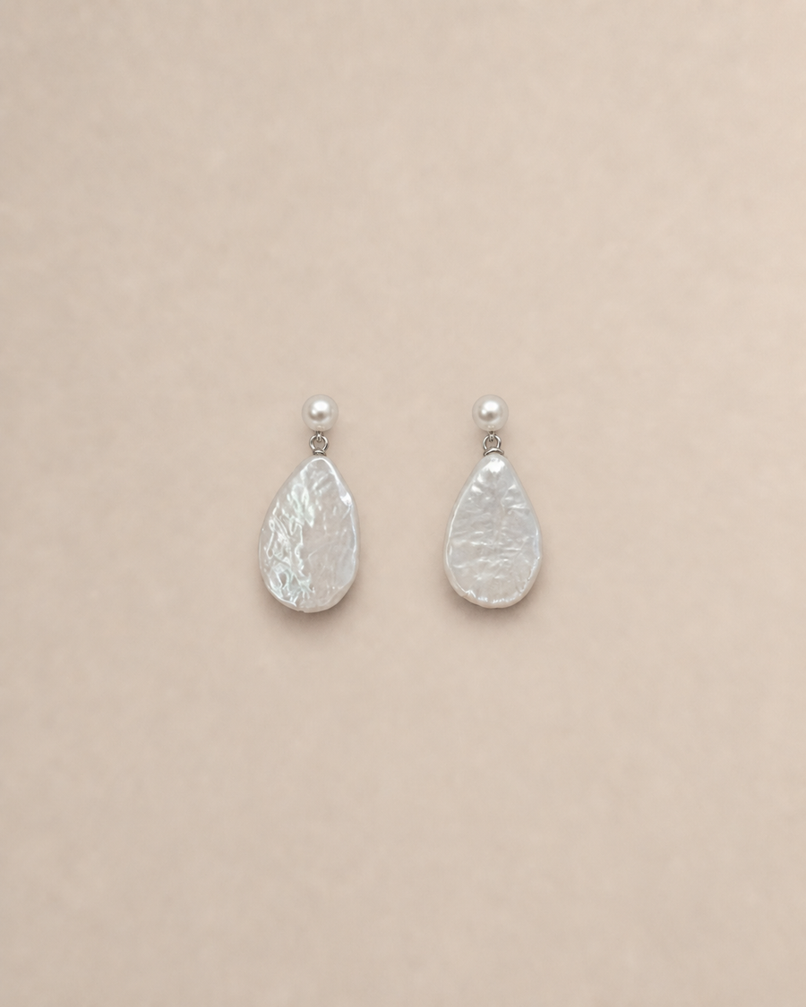 Lumen flattened baroque pearl drop earrings on warm greige