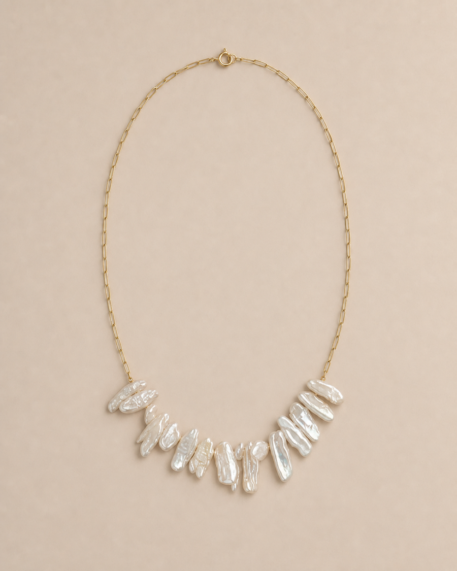 Crescent Biwa Pearl Necklace with irregular Biwa pearls on a warm greige background