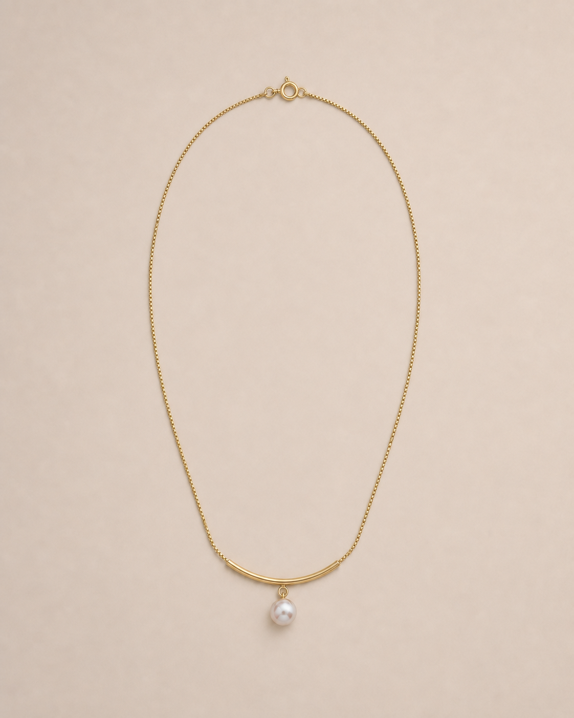 Arc Pearl Drop Necklace on warm greige background