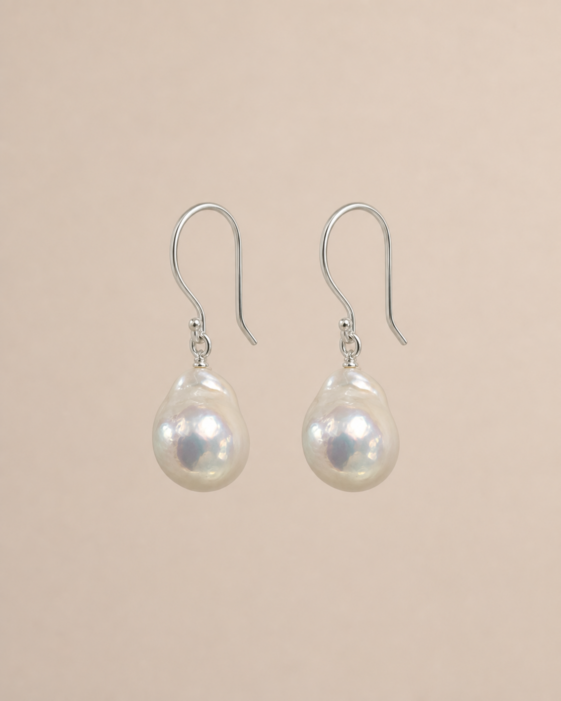 Drift Baroque Pearl Earrings on a warm greige background
