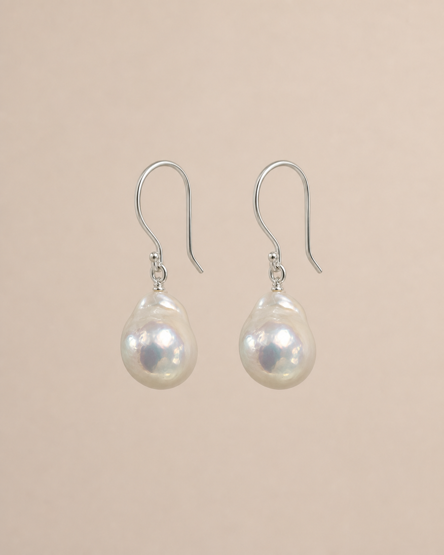 Drift Baroque Pearl Earrings on a warm greige background