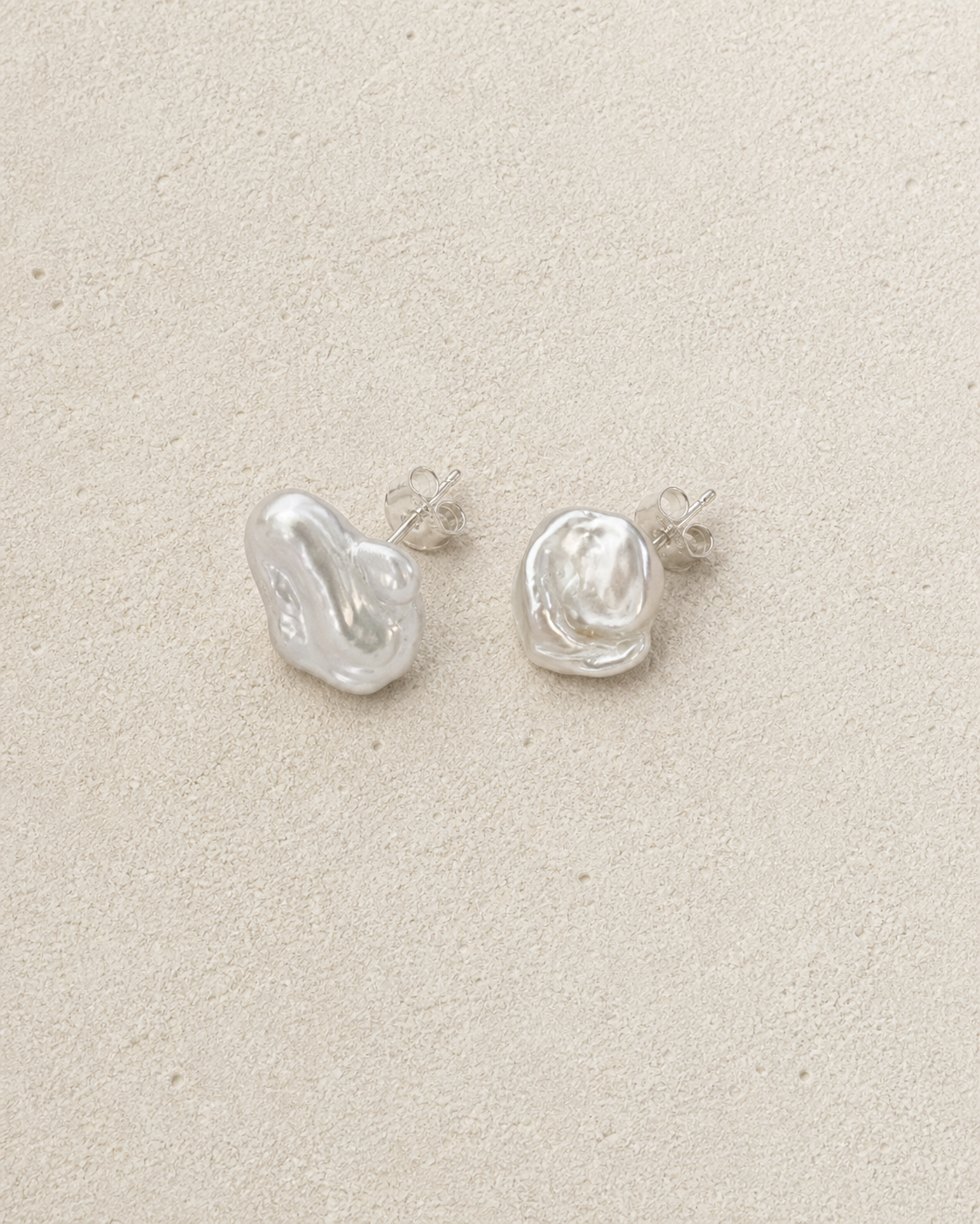 Mist Keshi Pearl Studs resting on warm ivory stone