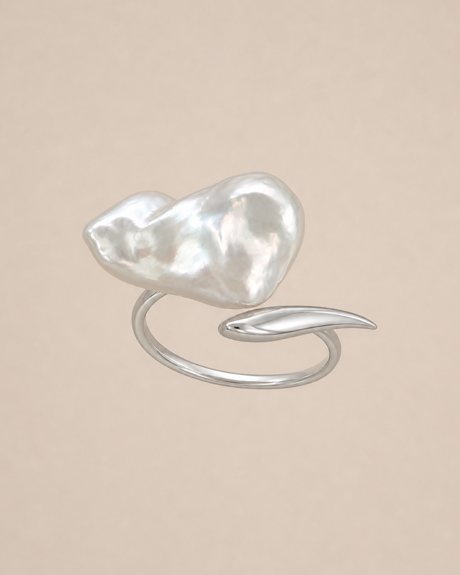 Veil Baroque Pearl Ring showing its open silver band, oversized baroque pearl and elongated leaf terminal