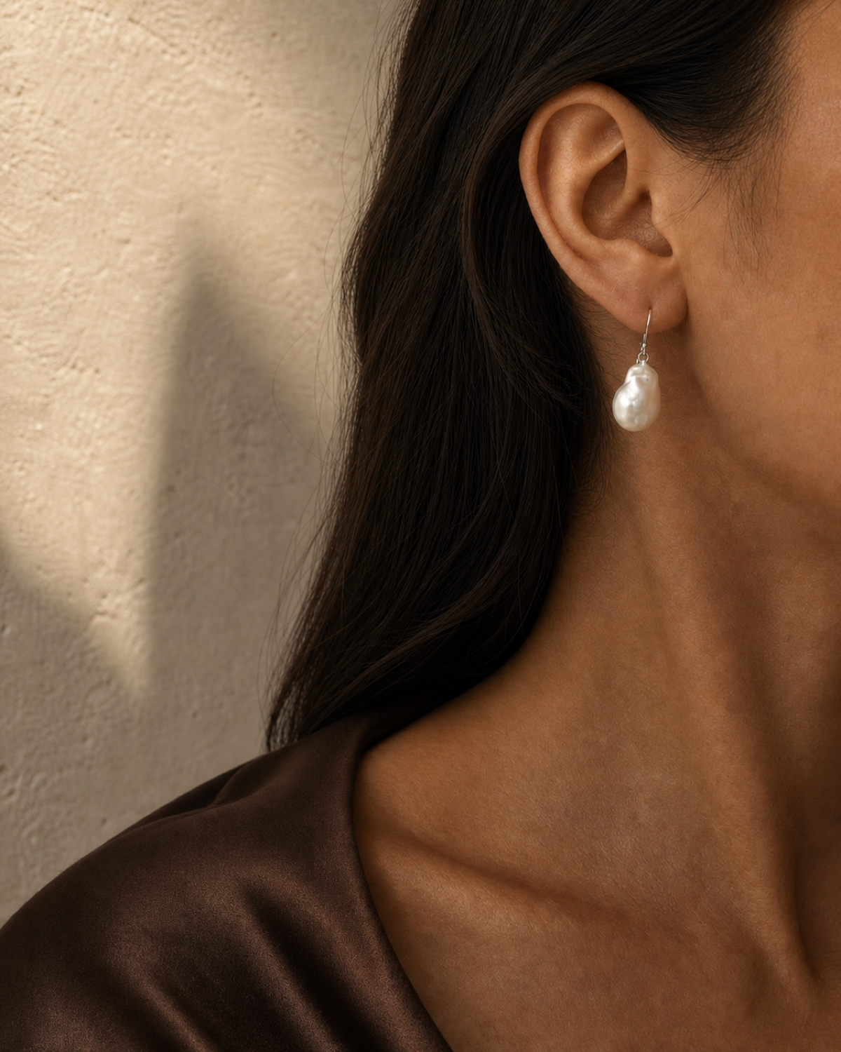 Drift Baroque Pearl Earring worn in a warm bronze and espresso editorial close-up