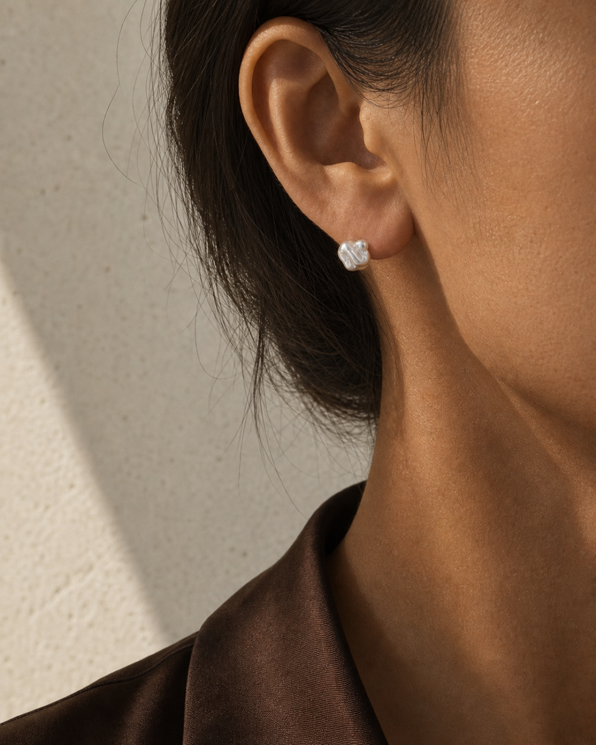Mist Keshi Pearl Stud worn in a warm bronze and espresso editorial close-up