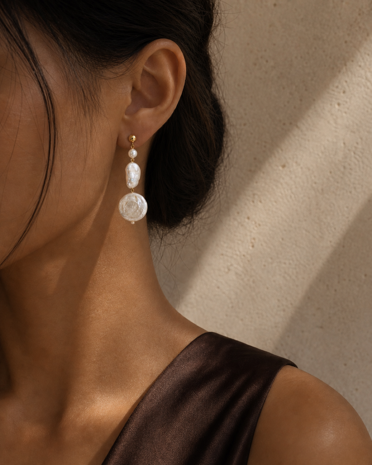 Luna Coin Pearl Drop worn in a warm bronze and espresso editorial close-up